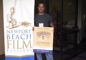 DREAMER director Dan Lund holds the poster for his documentary, at the Newport Beach Film Festival.