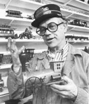 Animator Ward Kimball expresses interest in his train collection.